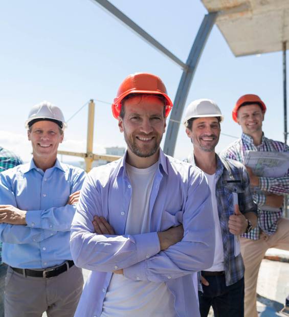 Builders Team Leader Over Group Of Apprentices At Construction Site, Happy Smiling Engineers Workers Teamwork Concept